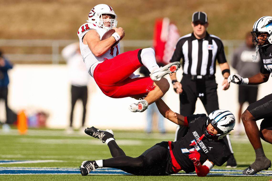 North Crowley safety Elijajuan Houston (7) tackles and flips Coppell quarterback Carter Zingelmann (11) in the air in a Class 6A Division I regional playoff Saturday, Nov. 29, 2025, at Midlothian ISD Stadium in Midlothian.