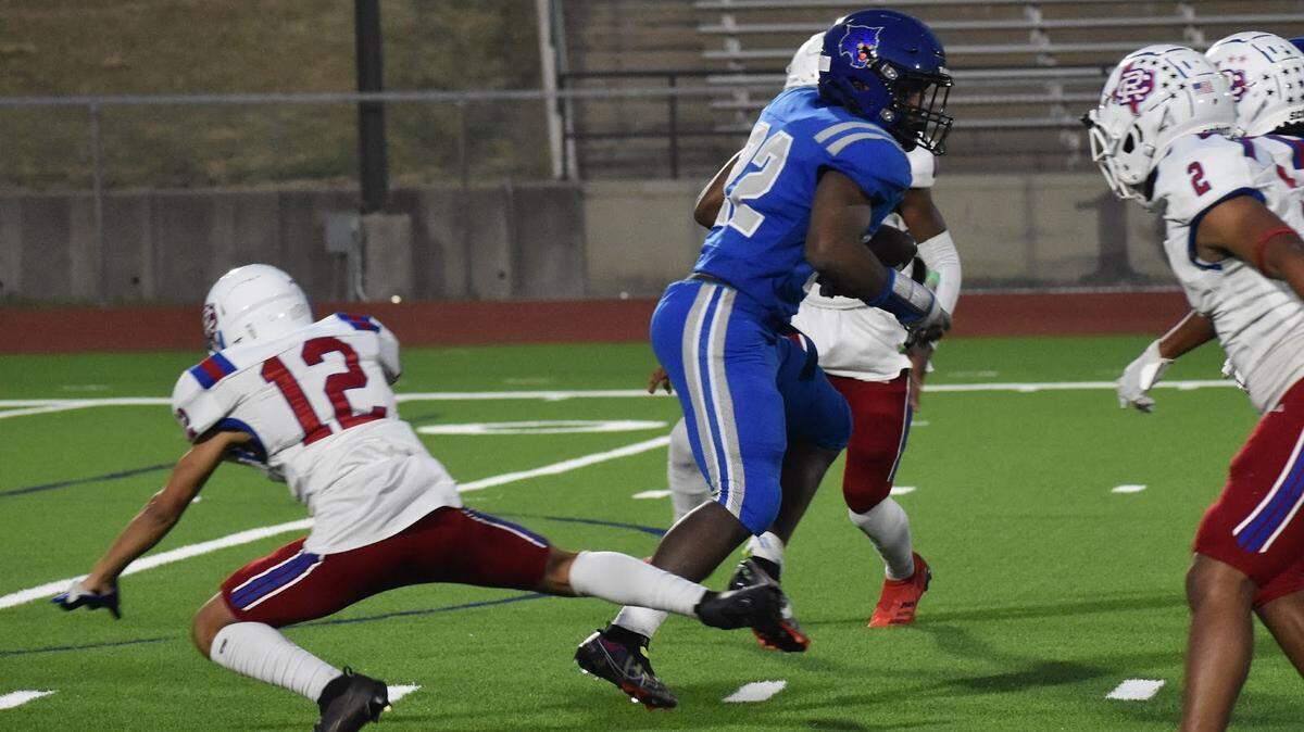 Dunbar’s Murray Moore (22) running the ball through Carter Riverside’s O-line, during a high school football game at Clark Stadium in Fort Worth, Texas, Friday, Oct. 7, 2022. Dunbar won 44-14. (Sofia Oo/Special to the Star-Telegram)