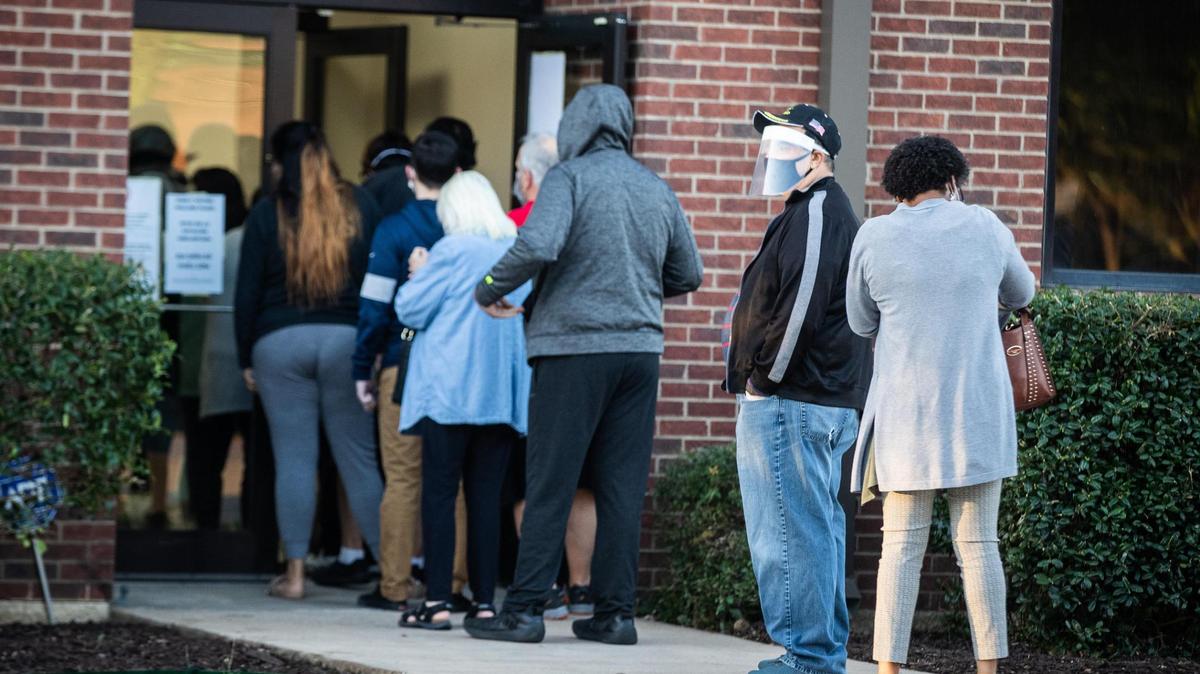 Voters wait in long lines on the first day of early voting in Tarrant County Tuesday, Oct. 13, 2020, in Fort Worth. Tarrant County has offered county-wide voting since November 2019.