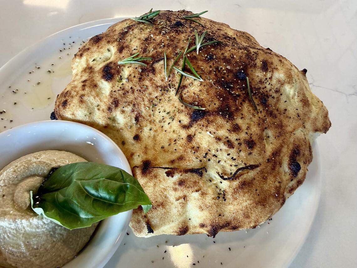 Puccia, a light semolina bread from Puglia, Italy, is a must-try appetizer at Acquario Pizza Pasta & Bar in Keller, Texas. It’s served with an eggplant spread.