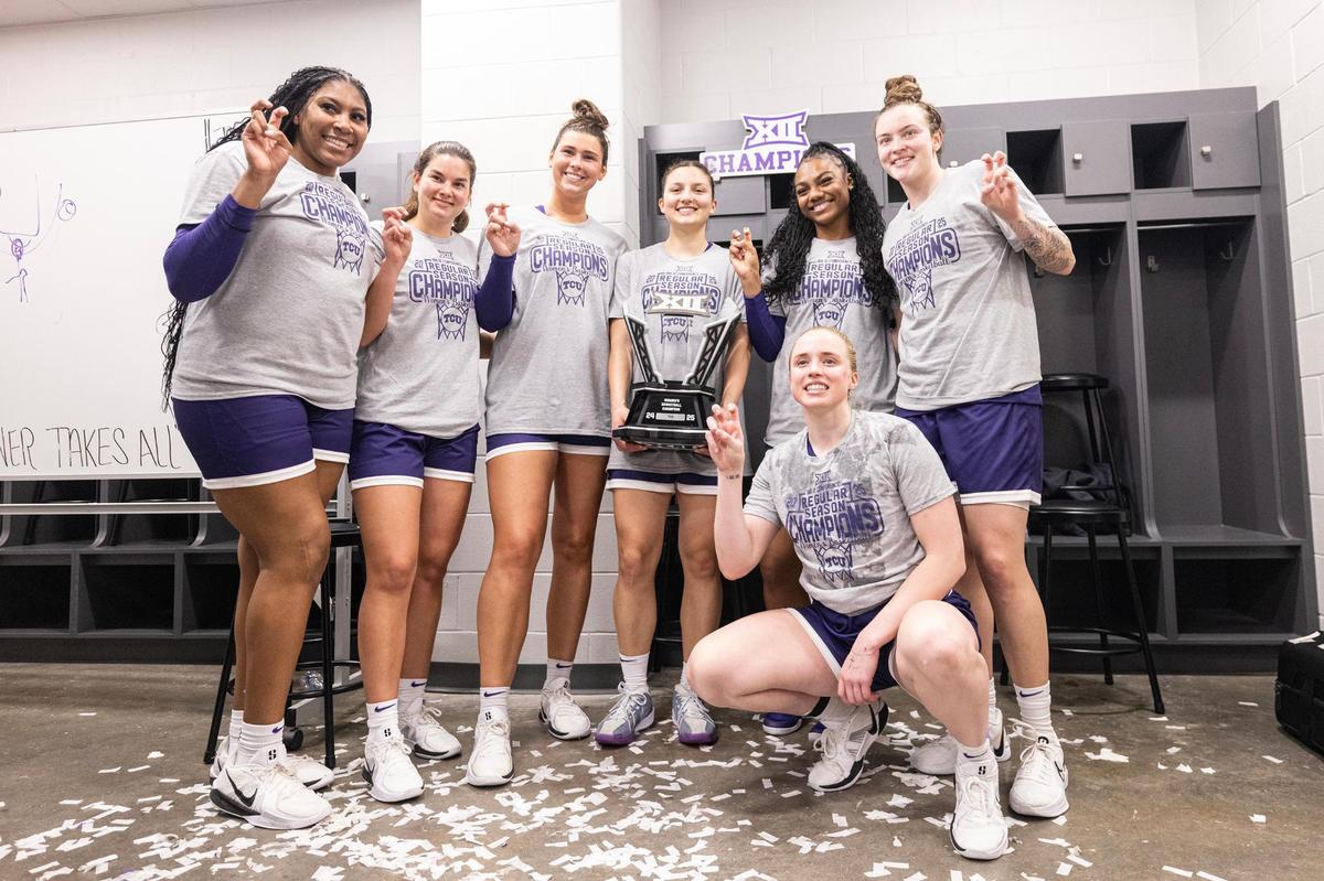Members of the TCU women’s basketball team take a photo with the Big XII Championship trophy in the locker room after defeating Baylor 51-48 at Foster Pavilion in Waco on Sunday, March 2, 2025.