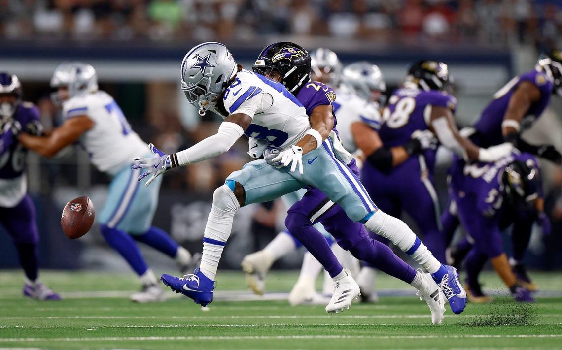 Dallas Cowboys wide receiver CeeDee Lamb fails to make a catch while under pressure from Baltimore Ravens free safety Ar’Darius Washington on Sunday at AT&T Stadium in Arlington.