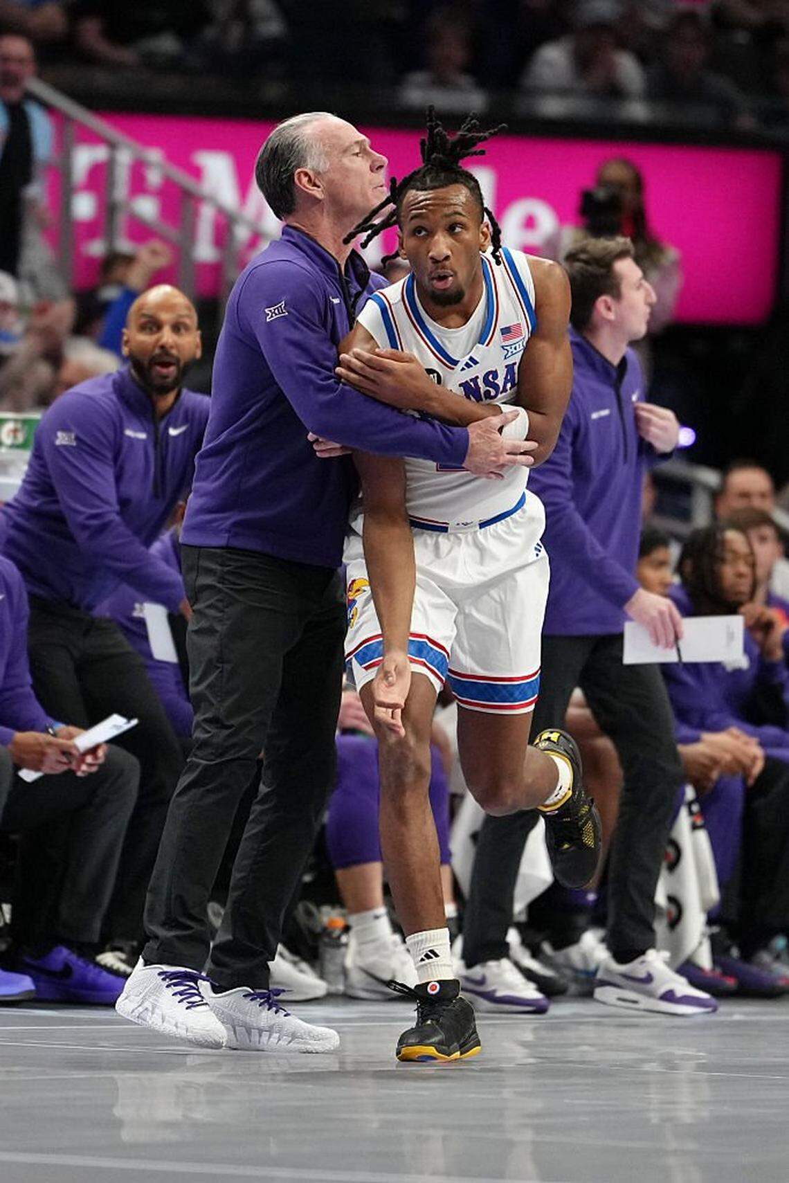 KANSAS CITY, MISSOURI - MARCH 12: Head coach Jamie Dixon of the TCU Horned Frogs collides with Darryn Peterson #22 of the Kansas Jayhawks in the first half during the quarterfinals of the Big 12 Tournament at T-Mobile Center on March 12, 2026 in Kansas City, Missouri. (Photo by Ed Zurga/Getty Images)