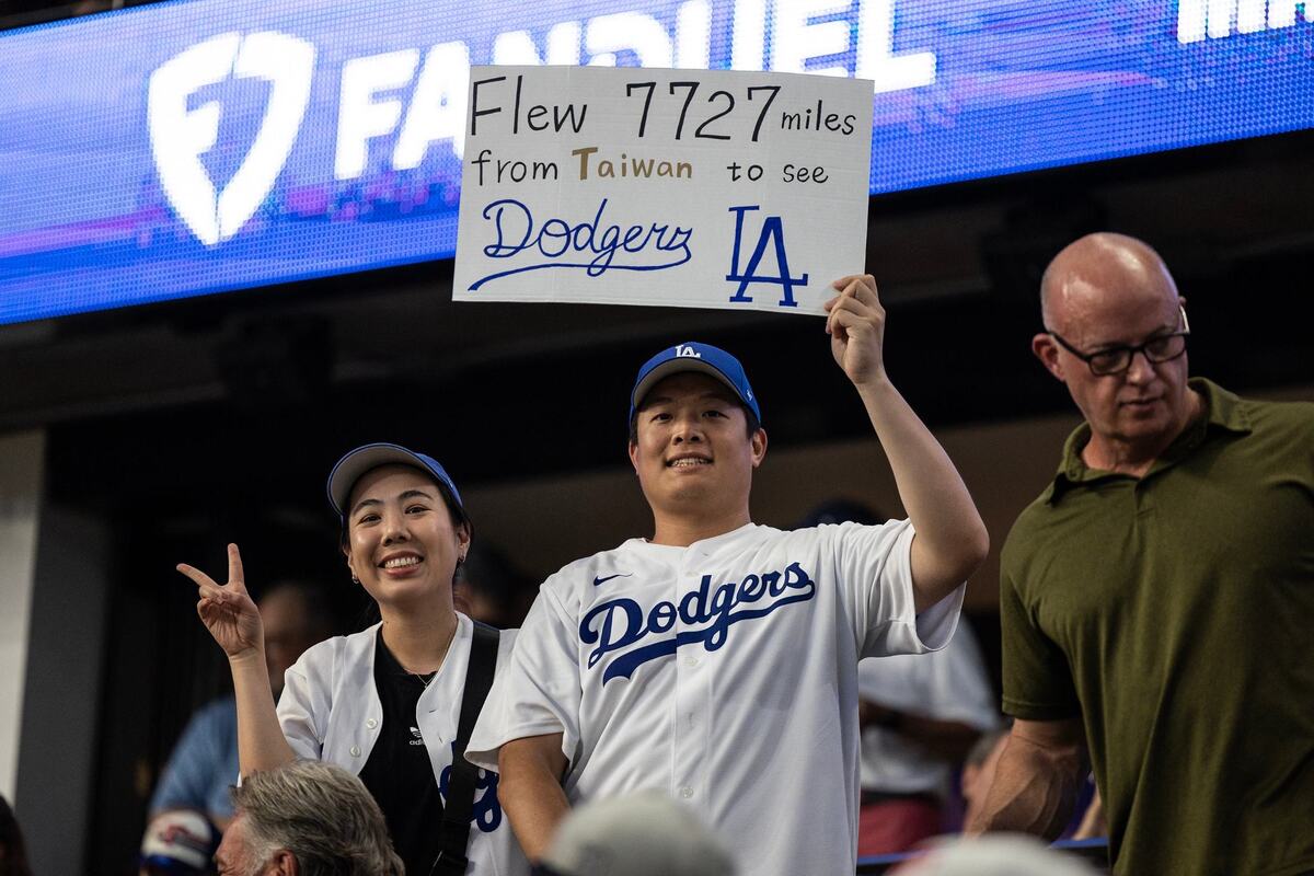 Los Angeles Dodgers fans from Taiwan hold a sign in support of their team prior to the 2024 MLB All Star Game at Globe Life Field in Arlington on Tuesday July 16, 2024.