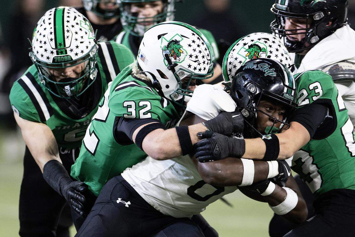 Prosper running back Bryce Robinson (6) is tackled by Southlake defenders in the first half of the UIL Division II Regional playoff game at Choctaw Stadium in Arlington on Friday, Nov. 28, 2025.