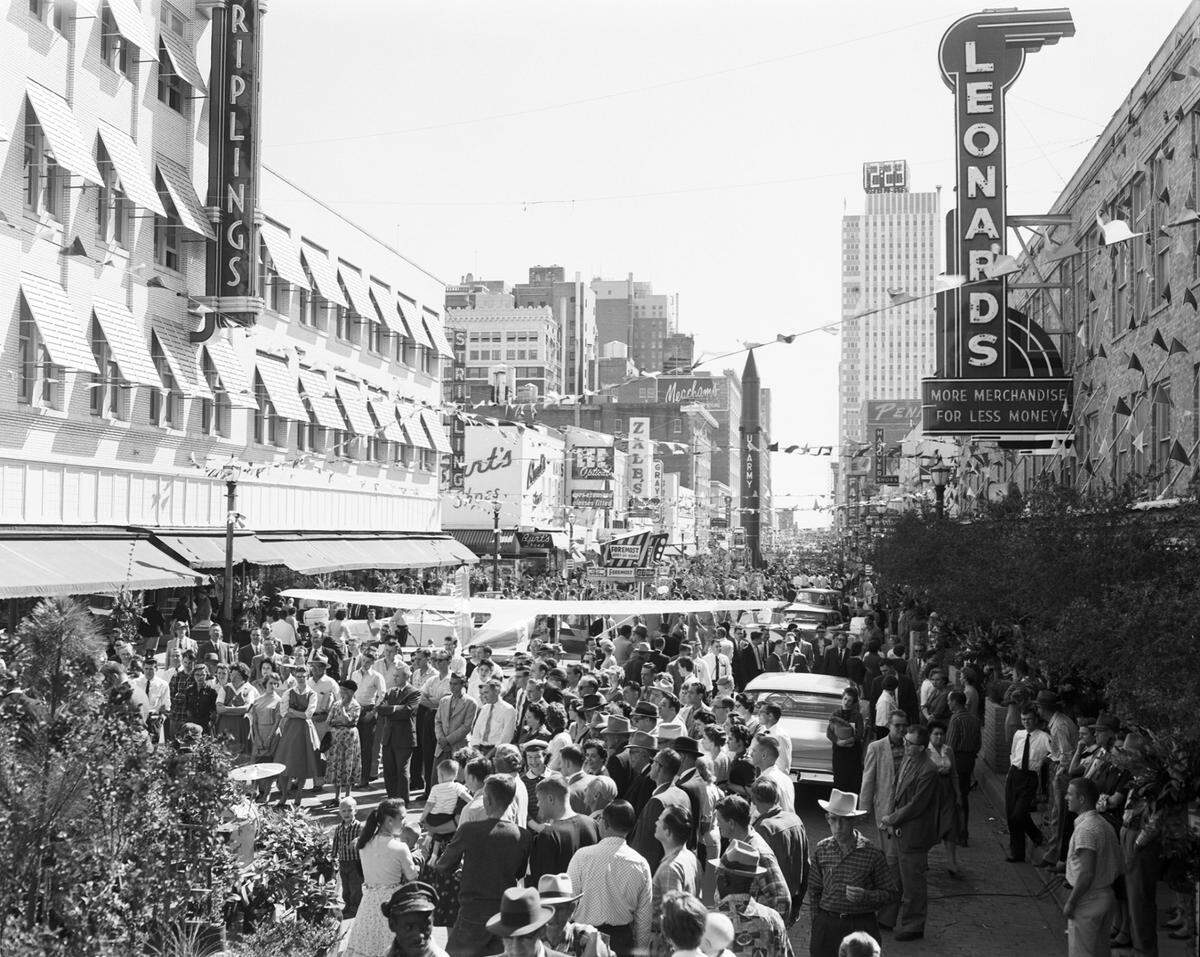 Looking south on Houston St., downtown Fort Worth; Striplings department store on left and Leonard’s department store on right; street blocked off for display of airplanes and rockets, 10/23/1958