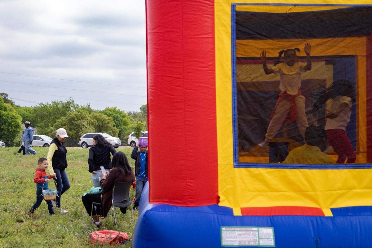 Children and families play at the Como Community Center before the egg hunt begins in Fort Worth on Saturday, April 8, 2023.