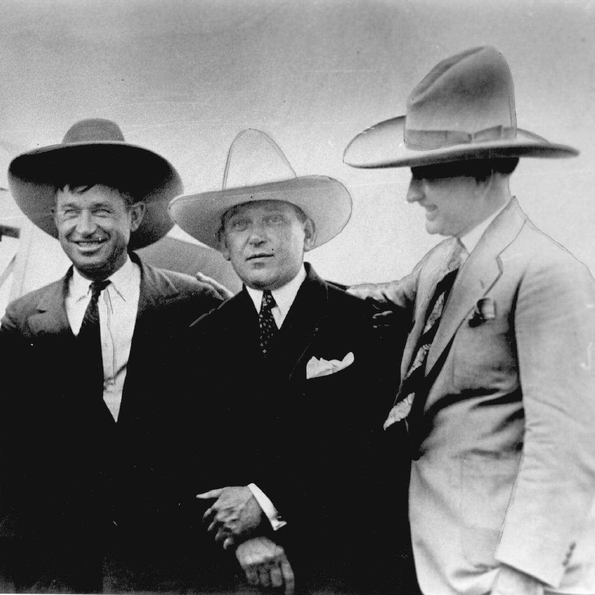 Will Rogers, left, and Amon Carter Sr., right, wearing 10-gallon hats.