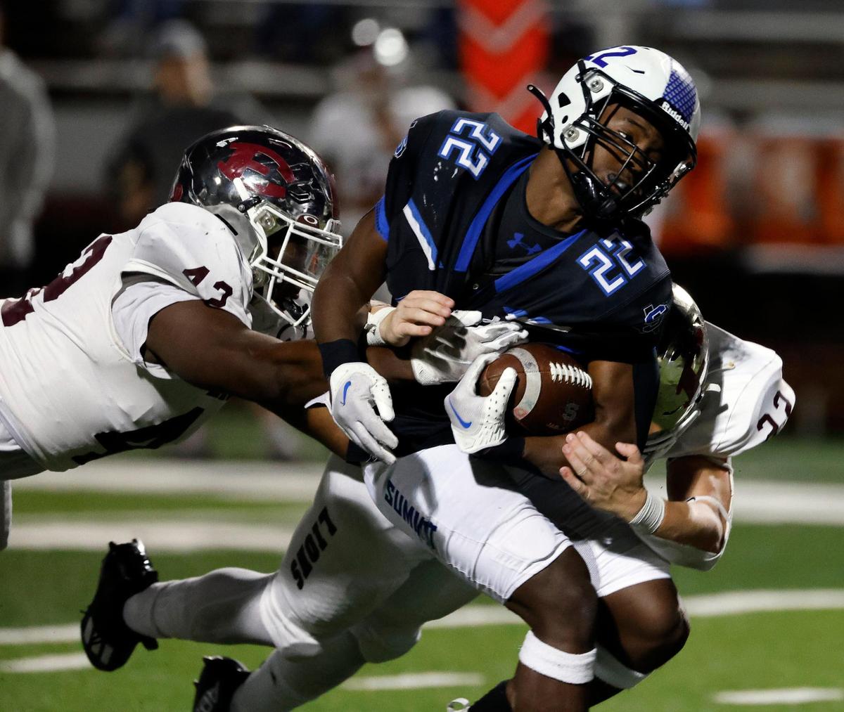 Summit’s Da’Vonte Johnson is brought down by Ennis defensive lineman Kingston Parker (42) and linebacker Malachi Perez (22) in the second half of a UIL football game at Vernon Newsom Stadium in Mansfield, Texas, Friday, Nov. 03, 2023. Summit defeated Ennis 28-21. (Special to the Star-Telegram Bob Booth)