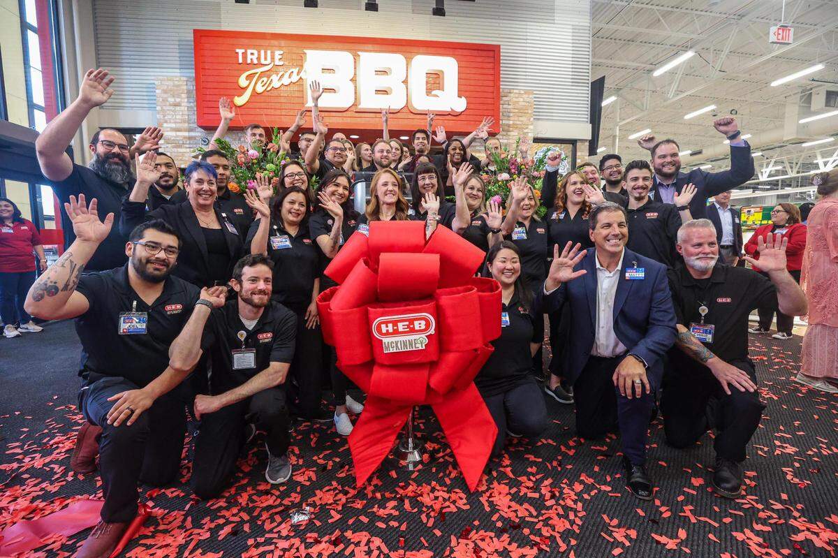 The management team of the new H-E-B Supermarket opening in McKinney, Texas gather for a group photo following their ribbon cutting event to celebrate its grand opening on Tuesday, July 18, 2023.