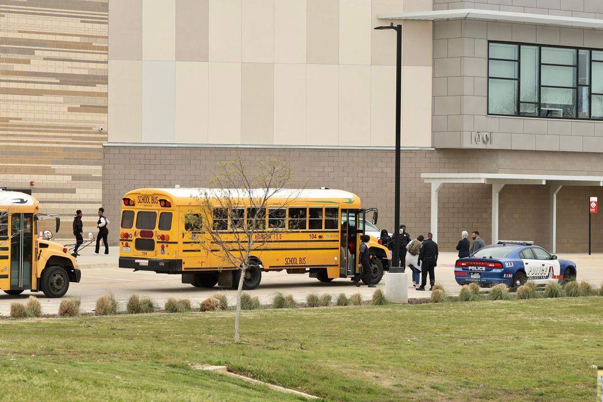 After an on-campus shooting led to a lockdown Monday morning, March 20, 2023, Lamar High School students were bused to the Arlington ISD Athletics Center to be picked up by their parents.
