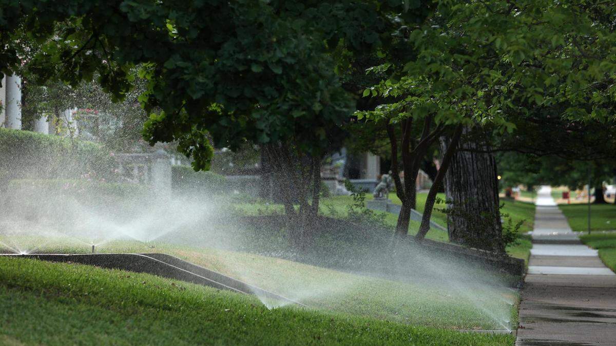 Sprinklers water the a lawn in the Ryan Place neighborhood of Fort Worth on Tuesday, August 9, 2022. Fort Worth has year-round outdoor watering restrictions to conserve water. Smart water meters are assisting the city in identifying properties that are violating the requirements.