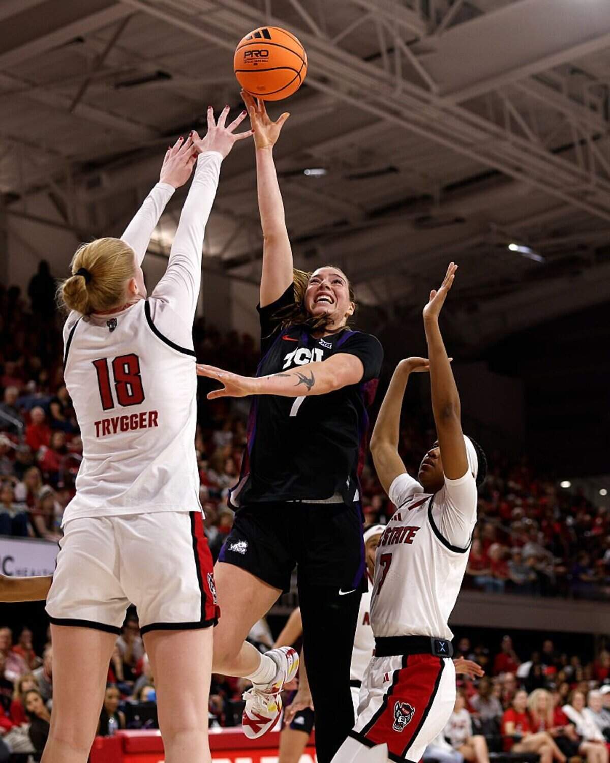 RALEIGH, NORTH CAROLINA - NOVEMBER 16: Marta Suarez #7 of the TCU Horned Frogs puts up a shot against Tilda Trygger #18 and Destiny Lunan #7 of the NC State Wolfpack in the second half at Reynolds Coliseum on November 16, 2025 in Raleigh, North Carolina. (Photo by Lance King/Getty Images)