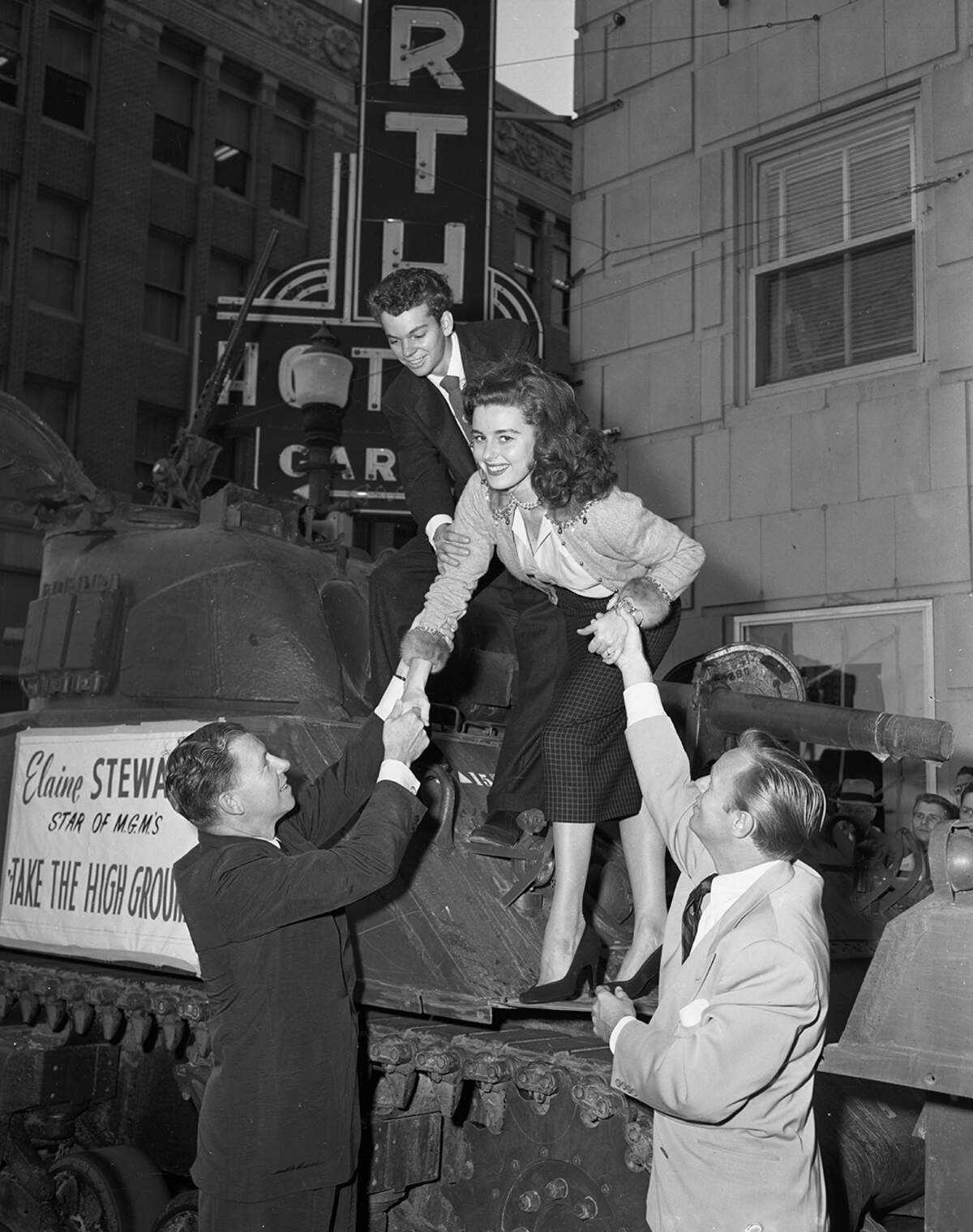 Sept. 26, 1953: “Elaine Stewart, MGM’s newest glamour girl, shows how to descend gracefully from a tank on her arrival in Fort Worth with an assist from George Murphy, left, and Richard Widmark, while Russ Tamblyn is ready to shove from behind.”