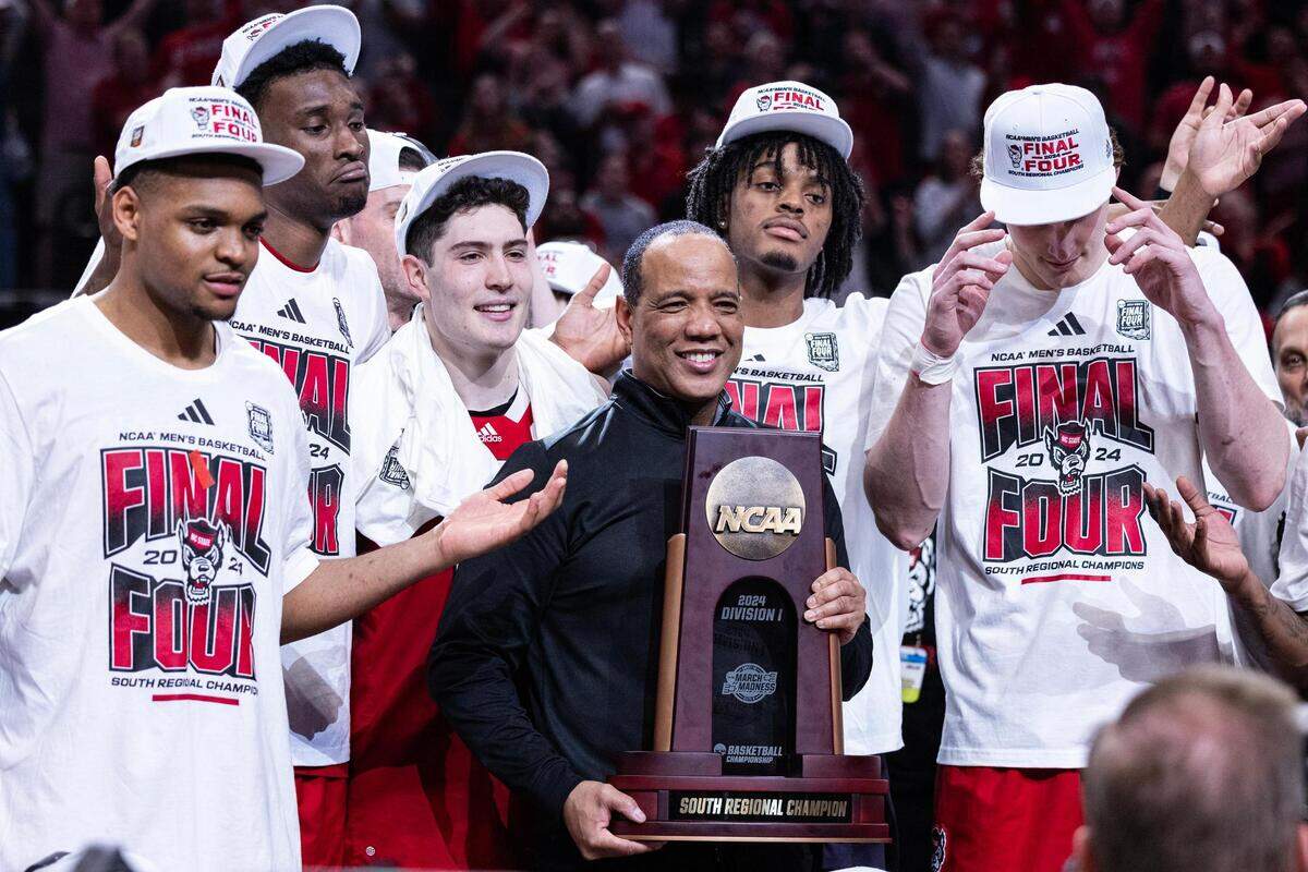 NC State Head Coach Kevin Keatts holds the South Regional Championship trophy after winning their Elite 8 South Regional match up against the Duke Blue Devils and advance to the Final Four of the NCAA Division I Mens Basketball Tournament at American Airlines Center in Dallas on Sunday, March 31, 2024. NC State defeated Duke 76-64.