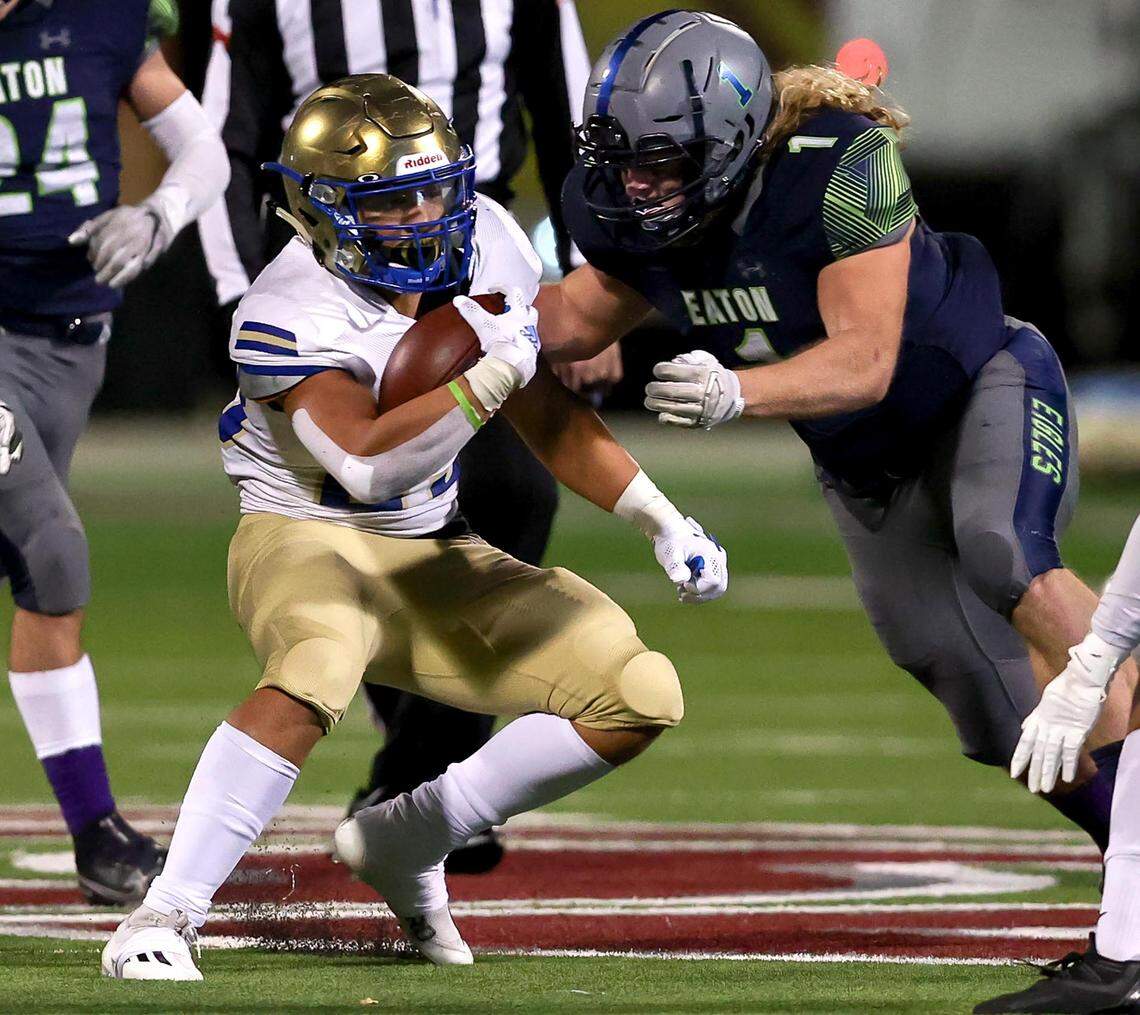 Fort Worth Boswell running back Ezra Carter (23) tries to elude Eaton linebacker Brock Hayward (1) during the first half of the 6A Bi-District Region I Division II High School Football playoff game played at Northwest ISD Stadium on Thursday, November 11, 2021, in Justin. (Steve Nurenberg/Special to the Star-Telegram)
