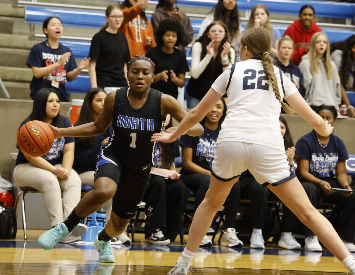 North Crowley guard Jamari Milton (1) turns the corner on Allen forward Katy Williams (22) during the first half of a UIL Class 6A Division I girls regional semifinals basketball playoff game at Grand Prairie High School in Grand Prairie, Texas, Tuesday Feb. 24, 2026.