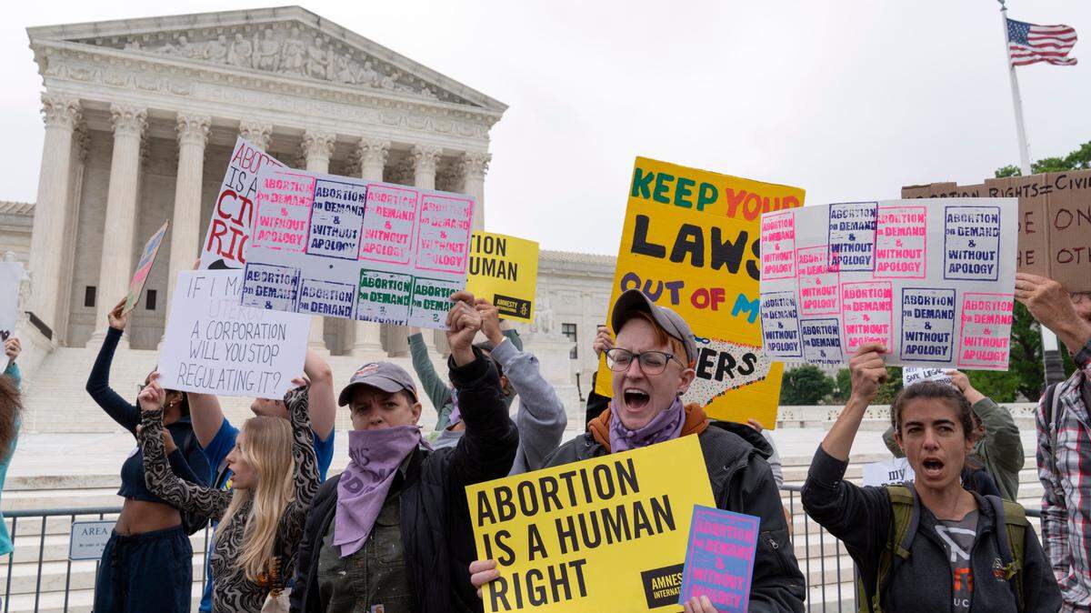 Demonstrators protest outside of the U.S. Supreme Court on Tuesday after the release of a draft opinion suggesting the court could be poised to overturn the landmark 1973 Roe v. Wade case.