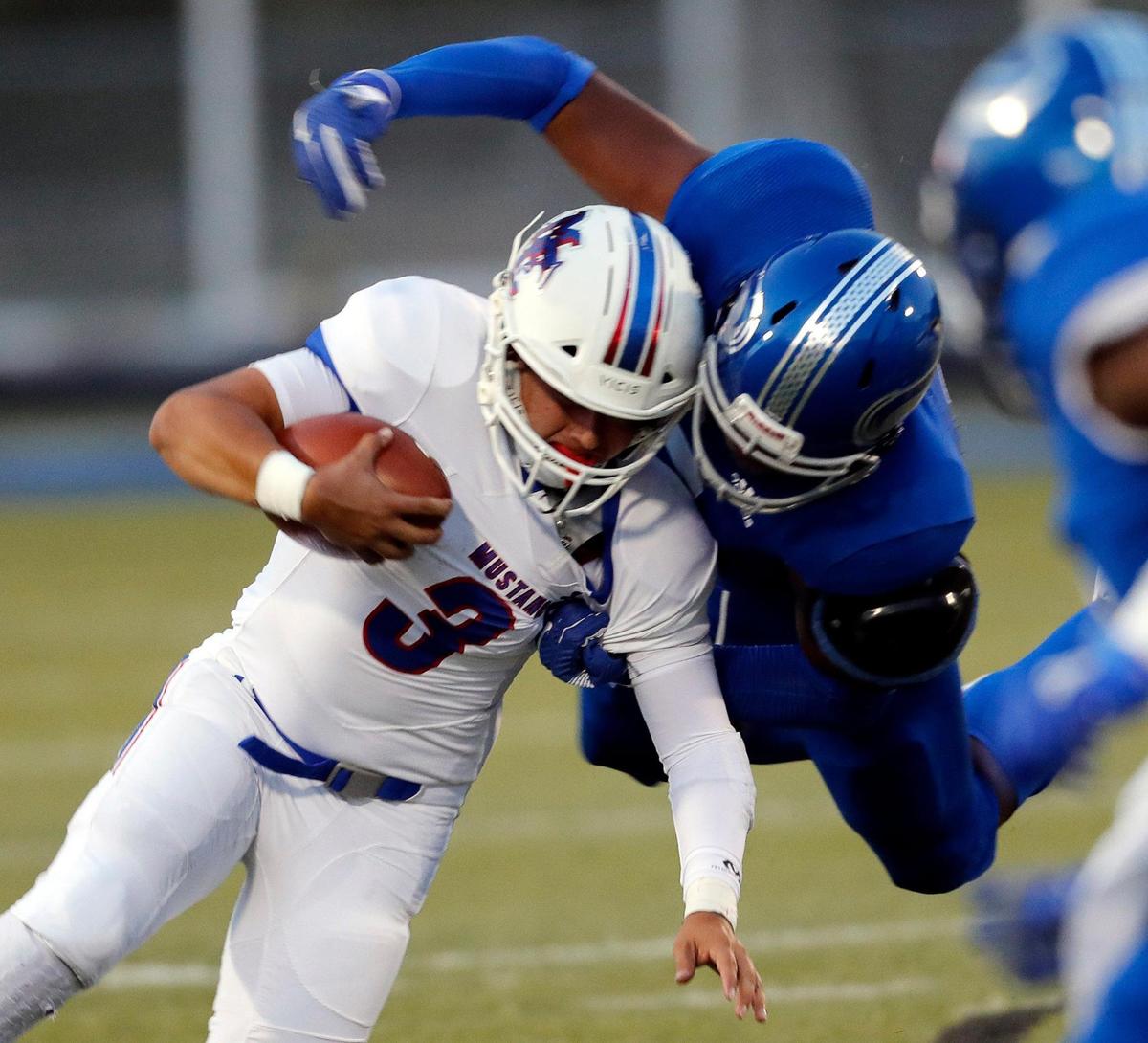 Midland Christian quarterback Ryver Rodriguez (3) is brought down by Nolan Catholic defensive lineman Curlee Thomas (9) during a high school football game at Doskocil Stadium in Fort Worth, Texas, Friday, Oct. 02, 2020. Nolan Catholic defeated Midland Christian 38-21. (Special to the Star-Telegram Bob Booth)