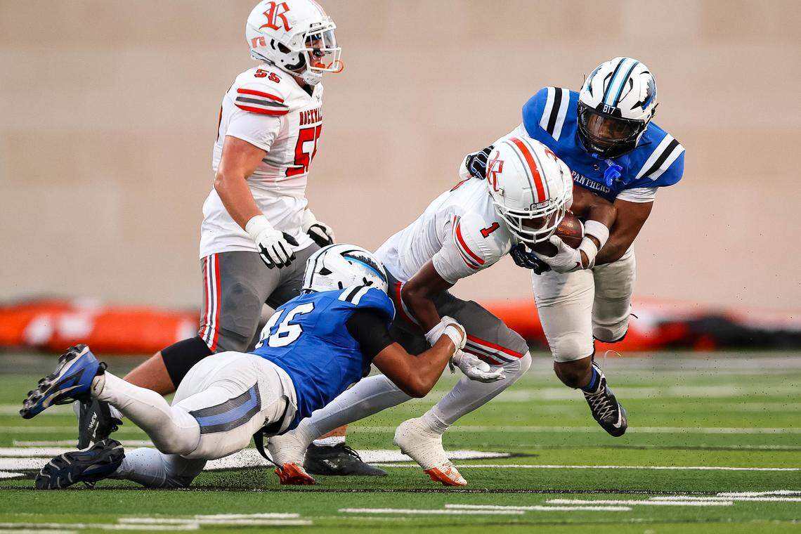 Two North Crowley defenders form to make a tackle on a Rockwall wide receiver in a non-district game between North Crowley and Rockwall at Crowley ISD Stadium in Crowley, Texas on Sept. 18, 2025.