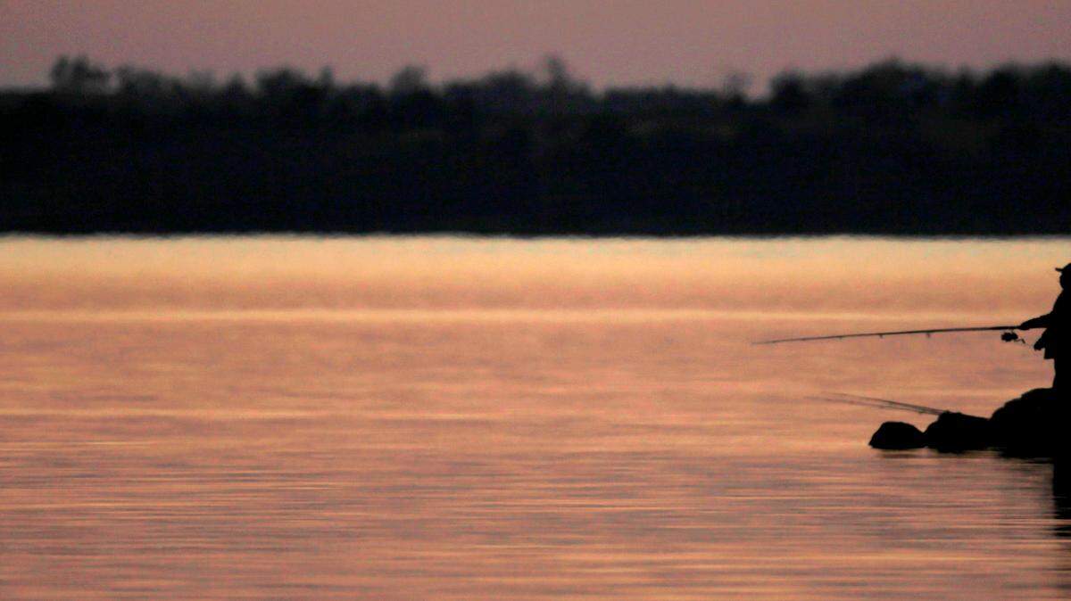 The 18-foot boat was found at the bottom of the lake, officials said. (AP Photo/Charlie Riedel)