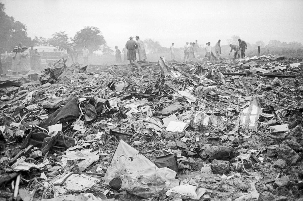 Pictured are rescue workers attempting to sift through wreckage of the plane.