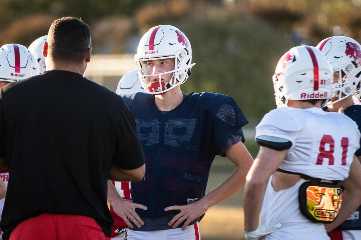 Quarterback Chase Cross listens to a coach during football practice Monday, Nov. 2, 2020, at Grapevine Faith. The team faces their rivalry, Fort Worth Faith, on Nov. 6.