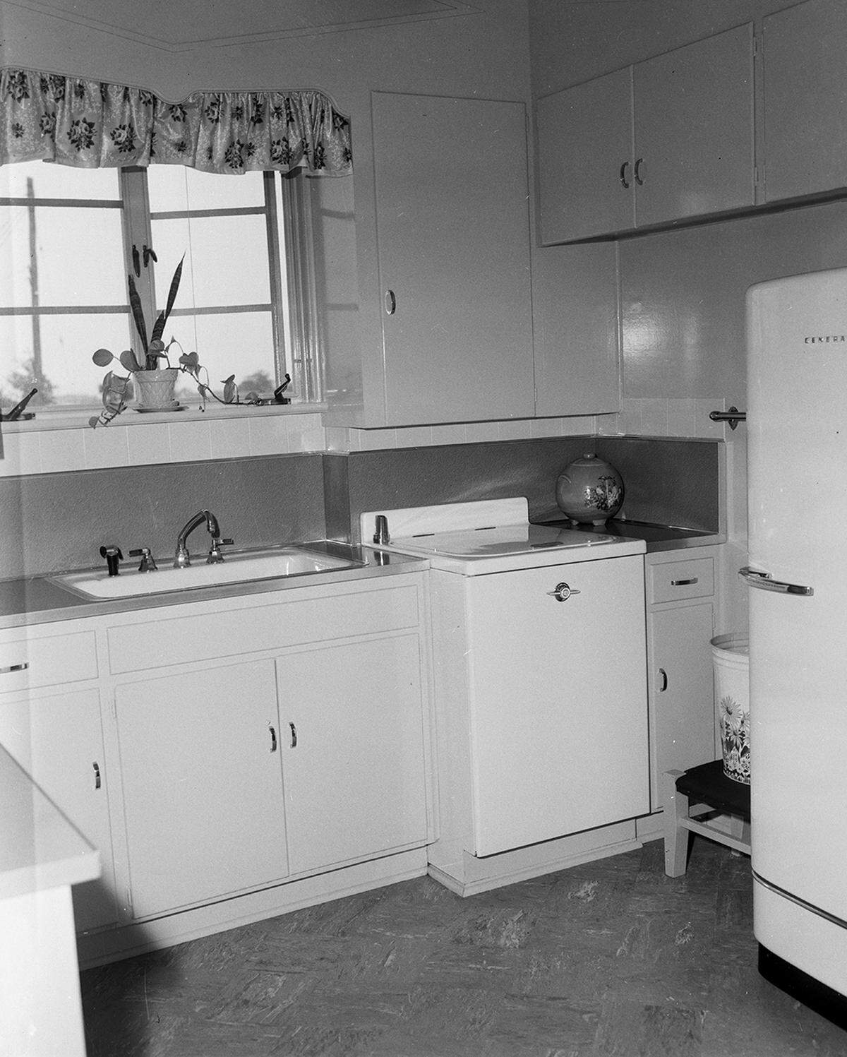 May 4, 1950: An electric dishwasher (at right) and a waste disposal unit (under the sink) are a part of the modern appliances found in the kitchen at the home of Mr. and Mrs. Noble Acuff, 6325 Waverly Way. Size of the kitchen in the 1950 house depends on the size of the dwellings. Larger homes like the Acuff dwelling have small but efficient kitchens. Smaller homes frequently have larger kitchens for combinations for dining or breakfast rooms.