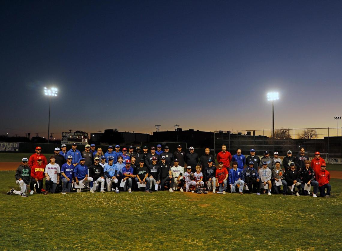Coaches, family and the 24 players who received a scholarship pose for a photo before the Drew Medford Memorial Tournament on March 12, 2022, at Paschal High School.