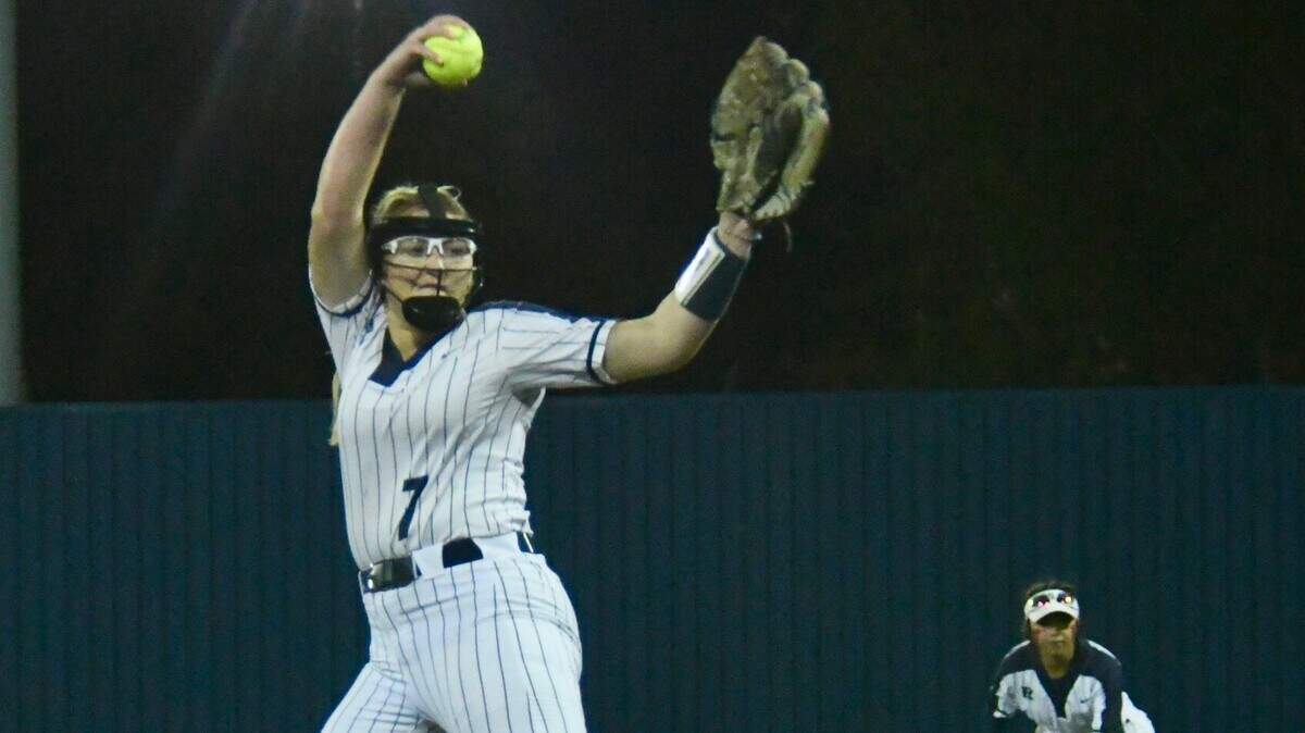 Richland pitcher Jacey Lees (7) delivers a pitch with second baseman Sam Aguilar at the ready against Birdville on Tuesday, March 19, 2024 at Richland High School. Richland defeated Birdville 2-0.