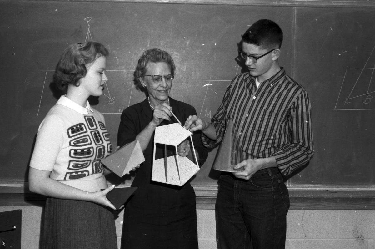 Feb. 20, 1959: Making light of a tough problem, solid geometry teacher Mrs. L.P. Hightower explains the angles to students Carol Barnes and Doug Ford at Paschal High School in Fort Worth.