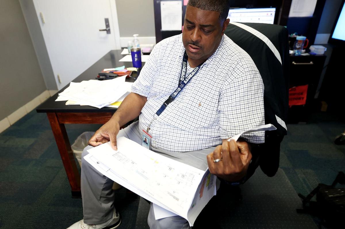 Wedgwood Middle School Principal Stanley Johnson looks over the renovation plans for the school on Tuesday, Sept. 10, 2024. The school received bond money for renovations, including new classrooms, that are expected to be completed in February of 2026. Wedgwood Middle took on around 220 sixth-grade students after all of the district’s stand-alone sixth-grade campuses were closed.