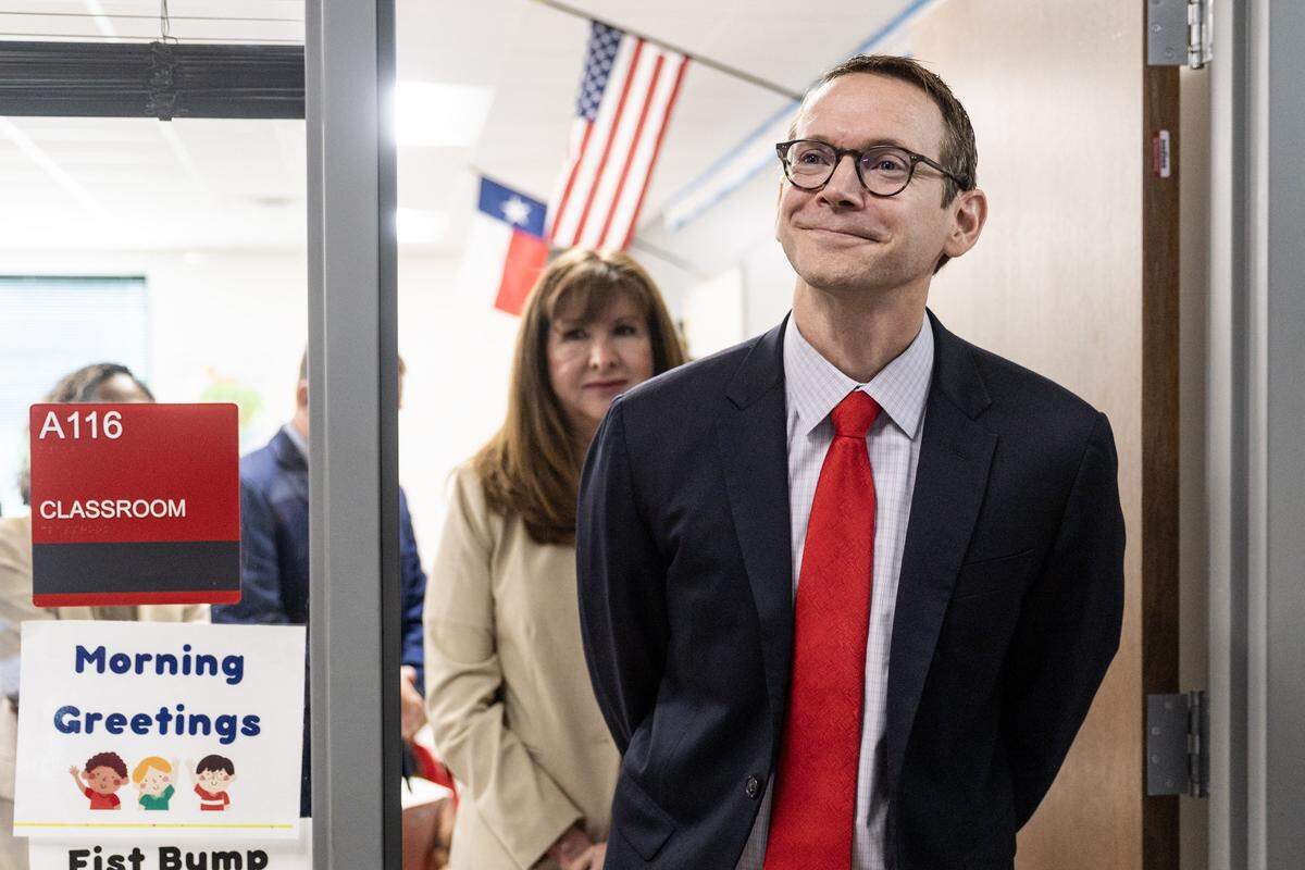 Mike Morath, the Texas Education Commissioner, tours through a classroom following a press conference regarding the updated A through F scores of Dallas and Fort Worth schools at Walnut Hill International Leadership Academy in Dallas on Friday, Aug. 15, 2025.