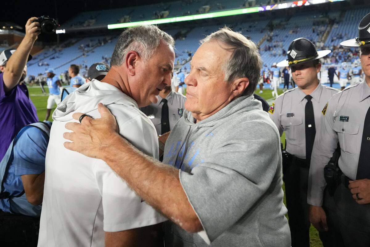 North Carolina Tar Heels head coach Bill Belichick, right, with TCU Horned Frogs head coach Sonny Dykes after the game Monday at Kenan Stadium in Chapel Hill, N.C.