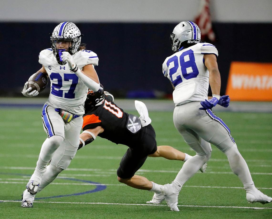 Burleson Centennial running back Aidan Hicks (27) gets away from Aledo safety Jake Gilliespie (0) in the second half of a UIL Class 5A D1 state quarterfinal football game at the Ford Center in Frisco, Texas, Friday, Dec. 02, 2022. Aledo defeated Centennial 42-21. (Special to the Star-Telegram Bob Booth)