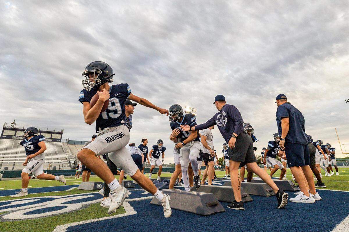 The Liberty Christian Warriors football team warms up before football practice at Warrior Stadium at Liberty Christian School in Argyle, Texas on Tuesday, Aug. 15, 2023.