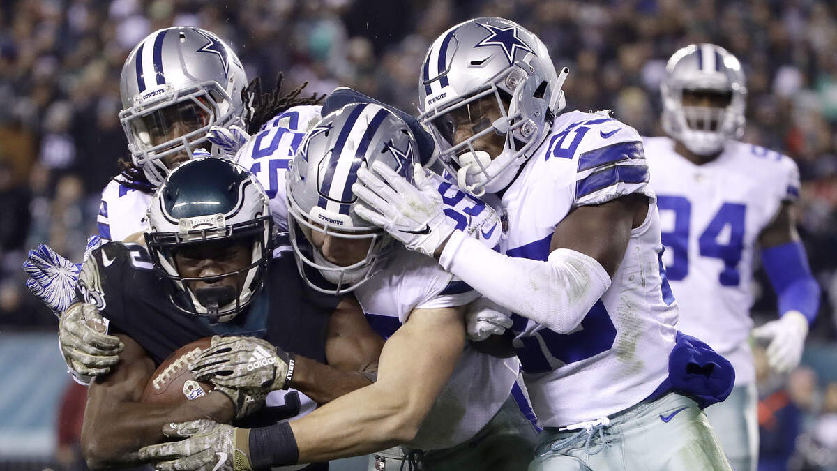 Philadelphia Eagles wide receiver Nelson Agholor is tackled by Dallas Cowboys middle linebacker Jaylon Smith, top left, outside linebacker Leighton Vander Esch, center, and free safety Xavier Woods in the second half of the Cowboys’ 27-20 Sunday night at Lincoln Financial Field.