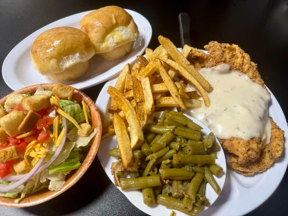 A chicken-fried chicken platter with green beans, fries, salad and rolls at Blue Mound Cafe in North Richland Hills.
