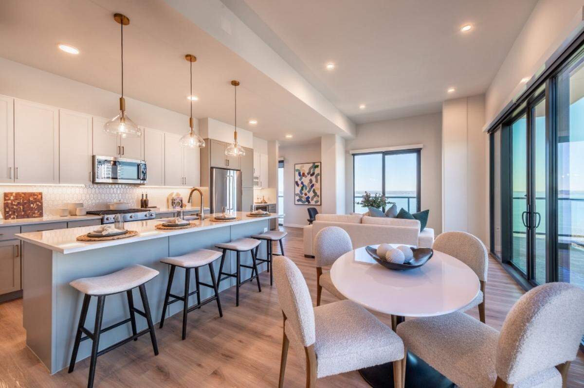 The kitchen and a wraparound balcony in a unit at Thirty-One Eleven Sunset, a 16-story, 207-unit luxury residential apartment tower overlooking Lake Grapevine in Flower Mound.