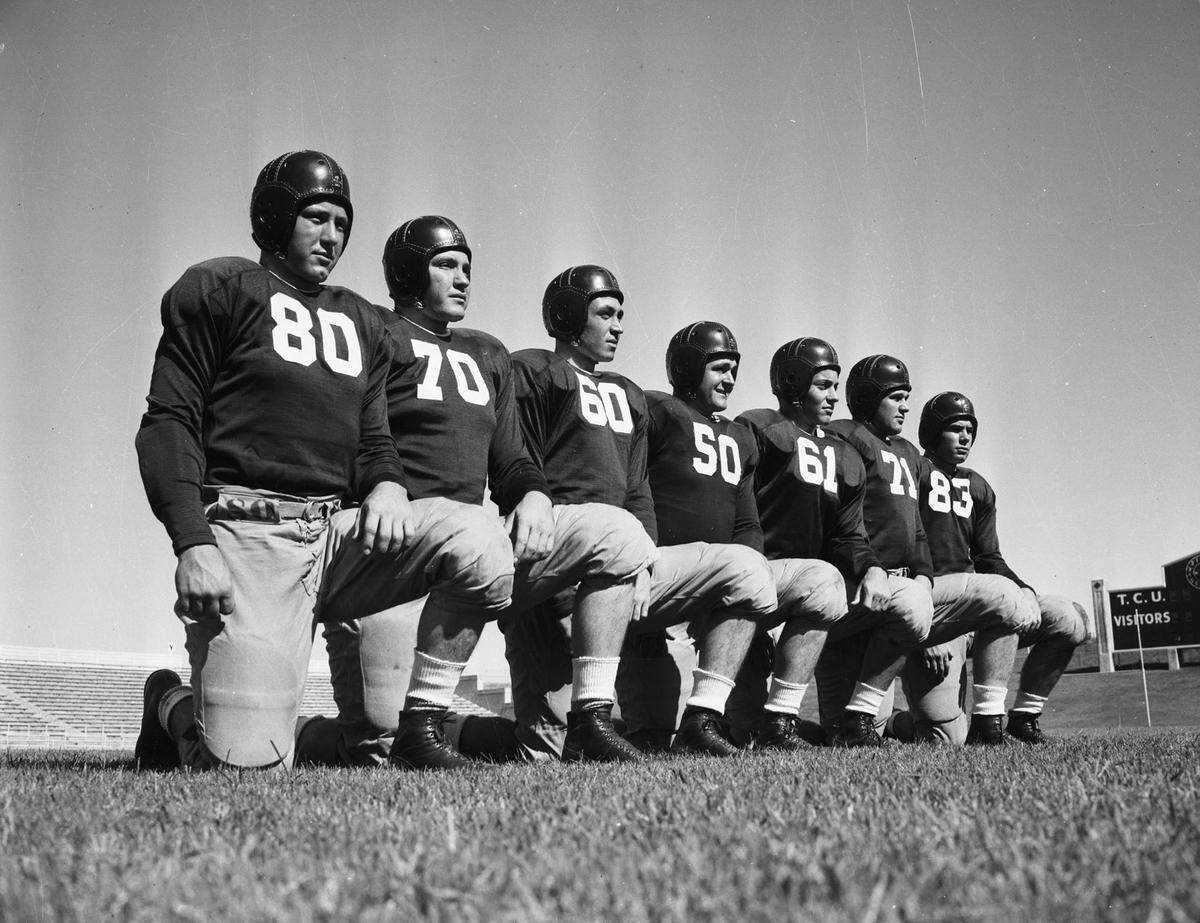 1941: Seven boys on the Texas Christian University football team will open the season as the starting line against Tulsa: Phil Roach (80), Woodrow Adams (70), Leonard Pugh (60), Billy Blackstone (50), Captain Bill Crawford (61), Derrell Palmer (71), and Bruce Alford (83). The Frogs are adopting a new numbering system this season with ends wearing 80s, tackles 70s, guards 60s, and centers 50s.