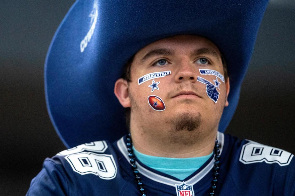Fans watch Dallas Cowboys quarterback Dak Prescott and the team warm up before their game against the Detroit Lions at the AT&T Stadium in Arlington on Sunday, Oct. 23, 2022.
