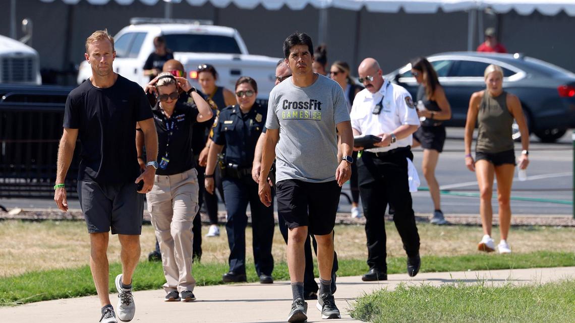 CrossFit CEO Don Faul, left, and Dave Castro, director of CrossFit games walk to a press conference followed by emergency personnel after an athlete drowned in Marine Creek Lake on Thursday, August 8, 2024, during the run swim event.