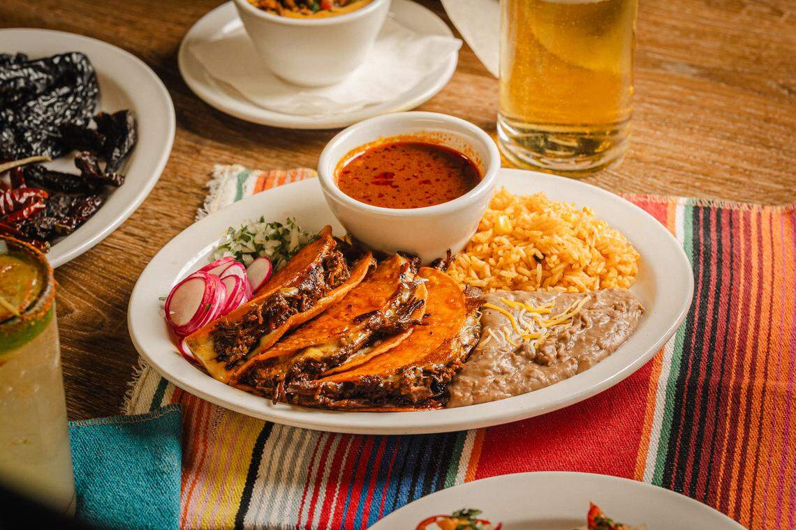 Quesabirria beef tacos with consome for dipping from Tacos & Avocados.