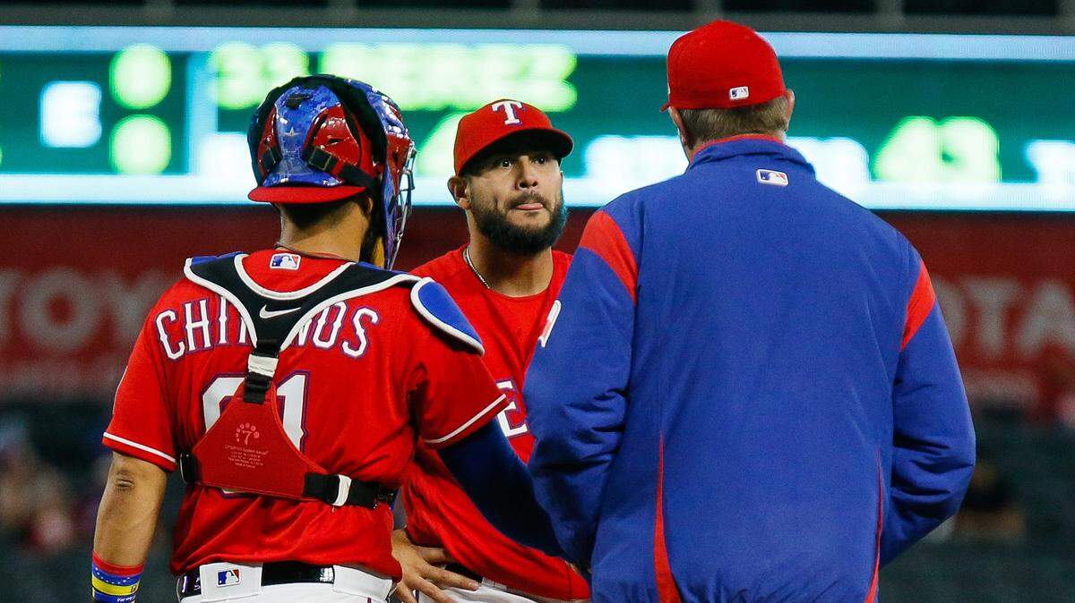 April 10, 2018; Arlington, TX, USA. Texas Rangers pitching coach Doug Brocail (46) visits starting pitcher Martin Perez (33) on the mound in the fourth inning against the Los Angeles Angels at Globe Life Park in Arlington, TX. Special to S-T/Ray Carlin
