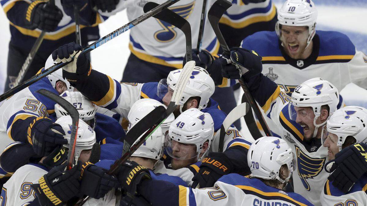 St. Louis Blues teammates mob Carl Gunnarsson, who scored the winning goal against the Boston Bruins during the first overtime period in Game 2 of the NHL hockey Stanley Cup Final, Wednesday, May 29, 2019, in Boston. (Bruce Bennett/Pool via AP)