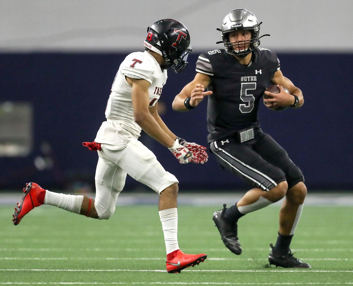 Denton Guyer quarterback Eli Stowers (5) tries to get around Amarillo Tascosa’s Jamison Horton (13) during the first half of the 6A Division II State quarterfinal high school football playoff game played at the Ford Center in Frisco, TX, Saturday, December 7, 2019.