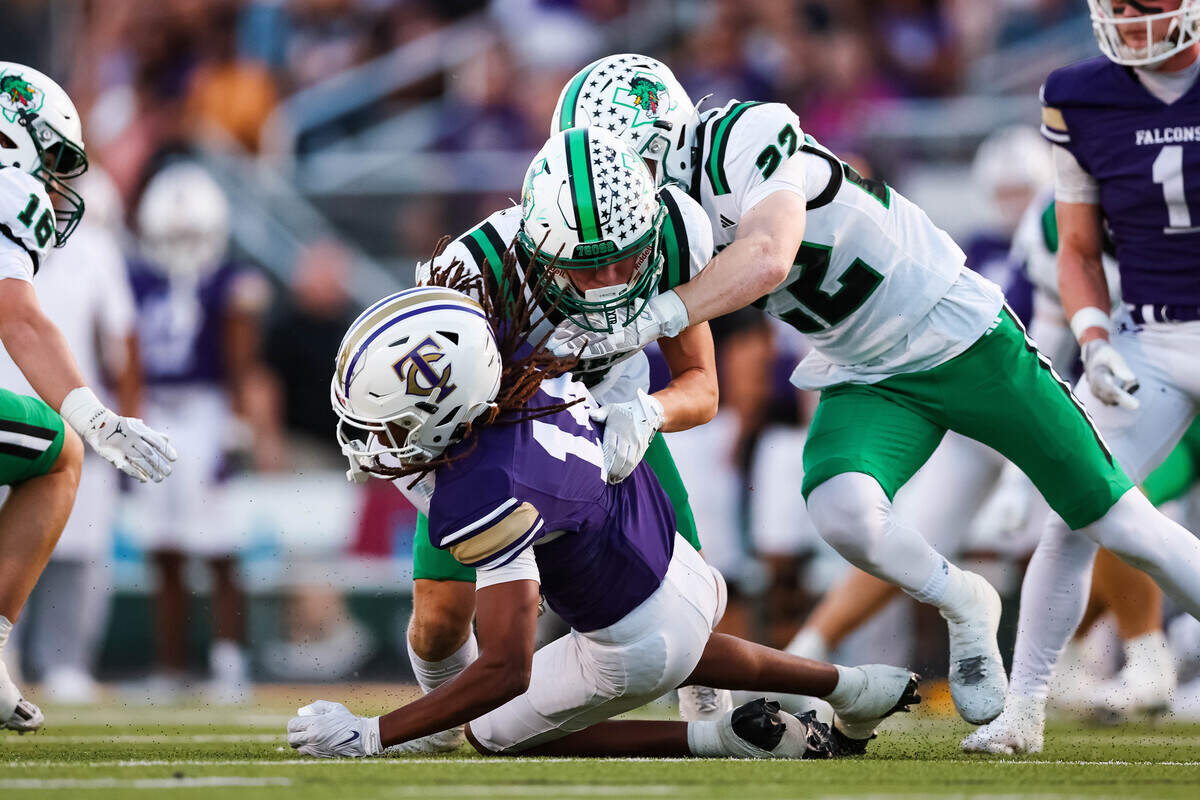 Two Southlake Carroll defenders make a tackle on a Keller Timber Creek wide receiver in a district matchup on Thursday, September 25, 2025 at Keller ISD Stadium in Keller, Texas.