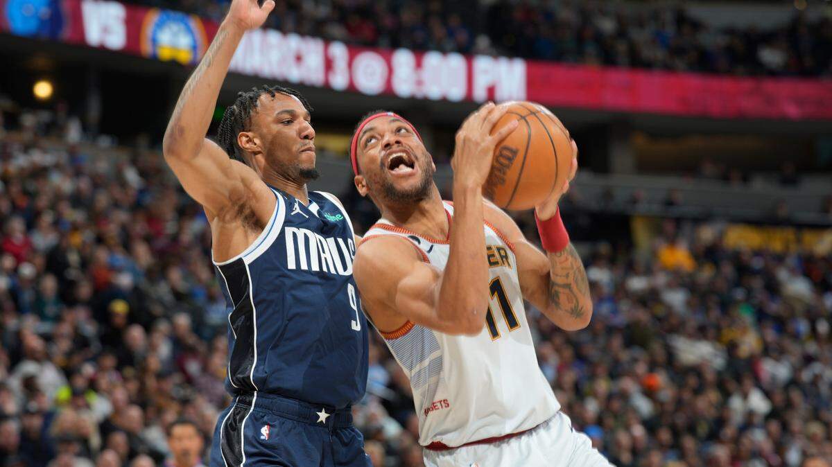 Denver Nuggets forward Bruce Brown, right, drives to the rim as Dallas Mavericks guard A.J. Lawson defends in the second half of an NBA basketball game Wednesday, Feb. 15, 2023, in Denver.