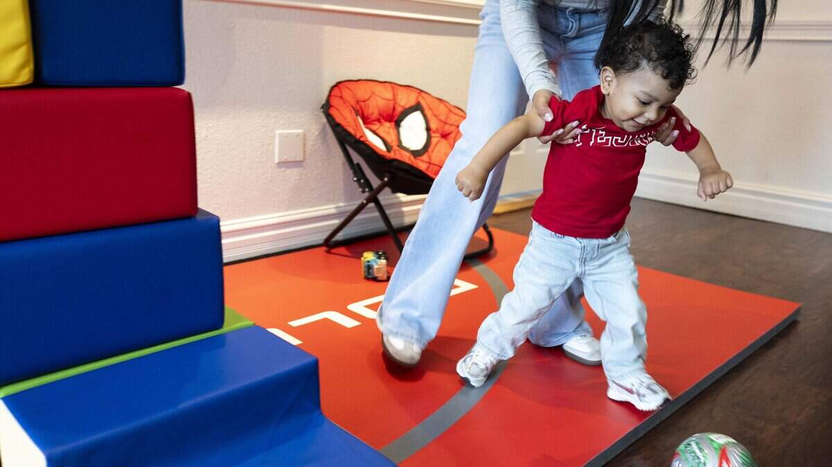 Lupita Vazquez helps her son Jesse Gonzalez Vasquez, 16 months old, kick a soccer ball on Wednesday, May 20, 2026 in Fort Worth, Texas. Vasquez was diagnosed with spinal muscular atrophy, a neuromuscular disorder that causes weakness in certain muscles.