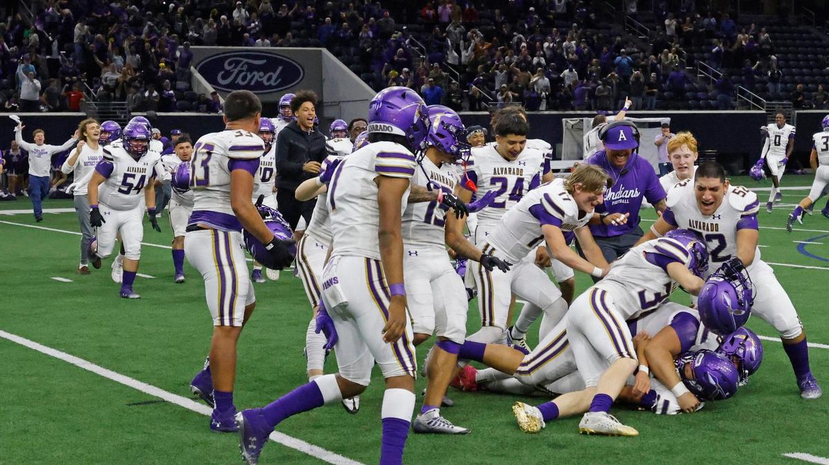 The Alvarado Indians pile on team mate Isaiah Sanchez after he kicked the winning field goal in double overtime during a UIL 4A D1 Area round football playoff game at The Ford Center in Frisco Texas, Thursday, Nov. 21, 2024.